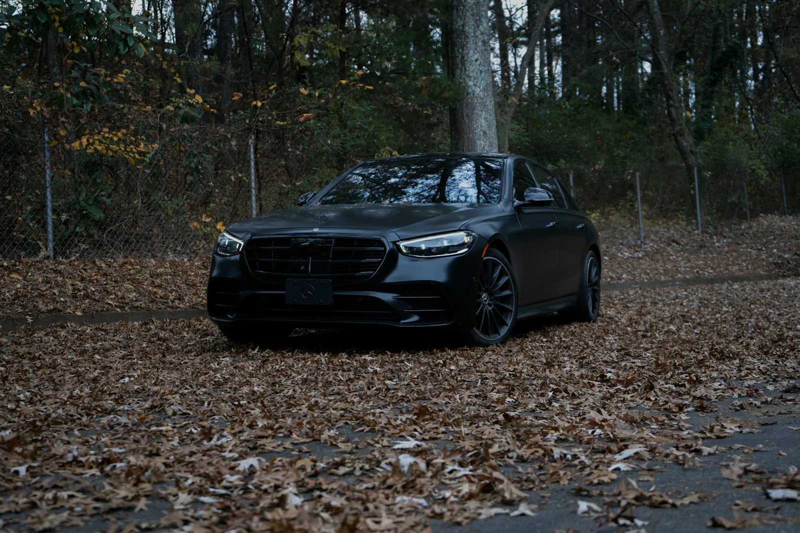 Black luxury sedan parked for pickup